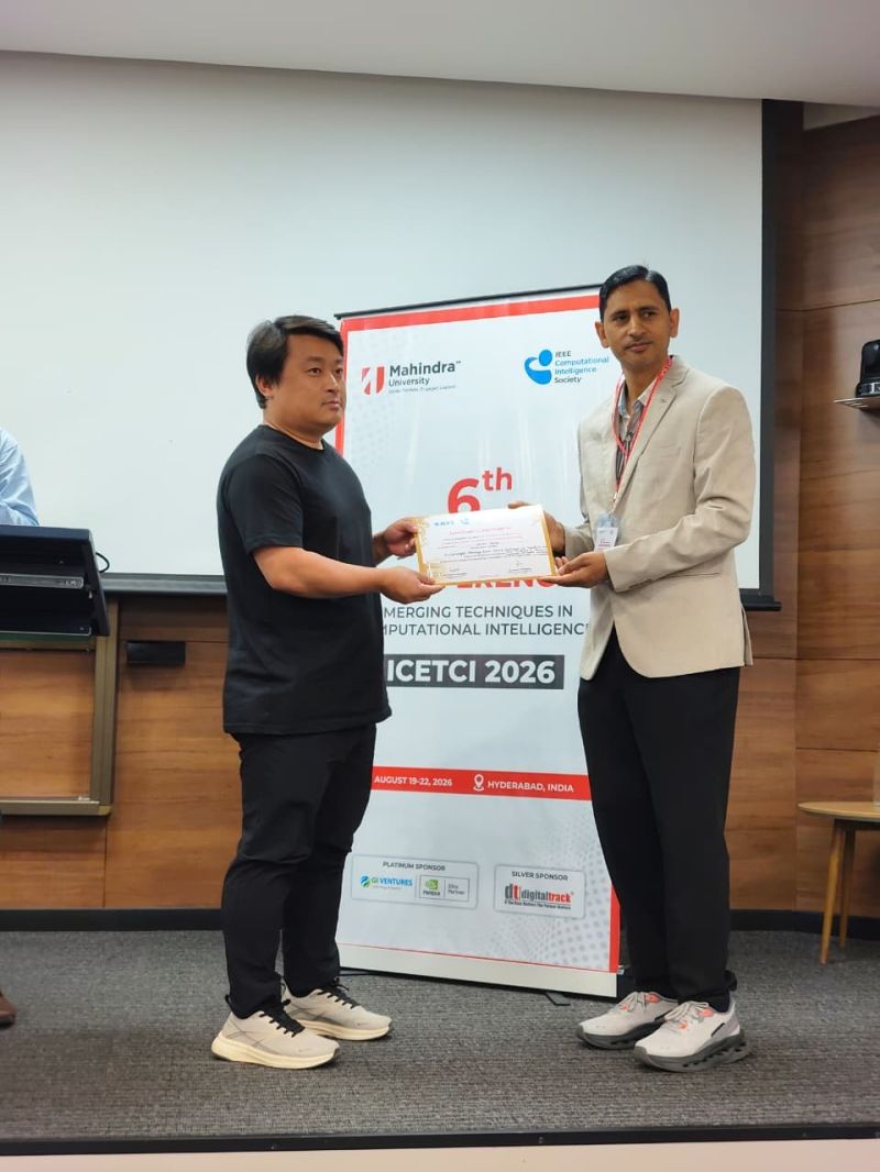 Sherab Gocha receives the Best Paper Presenter Award certificate on stage at ICETCI 2026