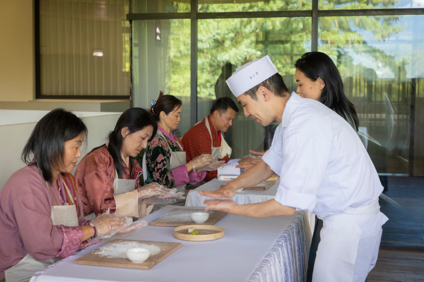 A Wakuden chef demonstrates shaping wagashi to the Selwa team in Thimphu